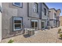 The backyard features a gravel area with an air conditioning unit and direct access to the home via sliding glass doors at 2534 Petunia Garden St # 222, North Las Vegas, NV 89081