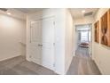Bright hallway features modern neutral colors, carpet flooring and doors leading to the bedrooms at 2534 Petunia Garden St # 222, North Las Vegas, NV 89081