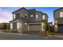 Contemporary two-story home with a gray exterior, attached garage, and well-maintained front yard landscaping at 2631 Chance Canyon St, Henderson, NV 89044