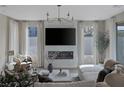 Inviting living room with a modern fireplace, TV, and elegant chandelier at 2631 Chance Canyon St, Henderson, NV 89044