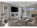 Stylish living room showcasing a fireplace, large television, and neutral decor at 2631 Chance Canyon St, Henderson, NV 89044