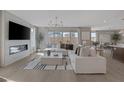 Bright living room featuring a fireplace, modern furniture, and large sliding glass doors at 2631 Chance Canyon St, Henderson, NV 89044