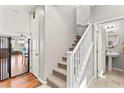 Bright hallway with staircase, white banister, and modern fixtures at 2672 Painted Mist Ct, Las Vegas, NV 89142