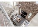 Overhead view of a modern living room featuring a brick wall, high ceilings, and ample seating at 3165 Via Como, Henderson, NV 89044