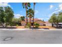 Charming home with mature trees, palm trees, and a long driveway leading to the attached two-car garage at 3341 Heavenly View Ct, Las Vegas, NV 89117