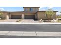 View of the home's spacious two-car garage with brick-paved driveway at 4140 Coneflower St, Las Vegas, NV 89135