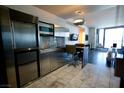 Efficient modern kitchen featuring stainless steel appliances, plus a dining area with bar stools at 4381 W Flamingo Rd # 3118, Las Vegas, NV 89103