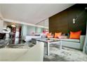 Cozy living room with a plush gray sofa, unique lighting, and a partial view of the kitchen at 4381 W Flamingo Rd # 3616, Las Vegas, NV 89103