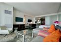 Open living space with a sleek entertainment center and partial kitchen view, bathed in natural light at 4381 W Flamingo Rd # 3616, Las Vegas, NV 89103