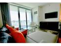 Bright living room featuring a modern entertainment center and city views through sliding glass doors at 4381 W Flamingo Rd # 3616, Las Vegas, NV 89103