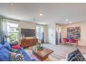 Open living area with dining space, modern decor, and lots of natural light at 48344 Orchid Ridge Ave # 104, Las Vegas, NV 89141