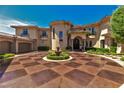 Elegant home with a circular driveway, water feature, and meticulously landscaped grounds at 5079 Mountain Top Cir, Las Vegas, NV 89148