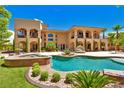 Backyard with a stunning pool, spa, covered patio, and lush landscaping perfect for outdoor living at 5079 Mountain Top Cir, Las Vegas, NV 89148