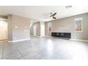 Bright living room with tile flooring and a built-in entertainment center at 5981 Smith Valley Rd, Las Vegas, NV 89148
