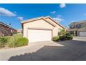 Charming single-story home featuring desert landscaping and a two-car garage at 6622 Black Oil Dr, Las Vegas, NV 89122
