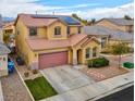 View of lovely two-story home with solar panels, desert landscaping, two-car garage, and quaint porch at 7129 Dillseed Dr, Las Vegas, NV 89131