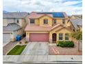 Inviting two-story home featuring a well-manicured lawn, desert landscaping, and a two-car garage at 7129 Dillseed Dr, Las Vegas, NV 89131