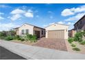 Charming single-story home with a two-car garage and landscaped front yard at 720 Webber Park St, Henderson, NV 89011