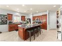 Spacious kitchen with granite countertops, stainless steel appliances, and an island with barstool seating at 7641 Lani Dawn St, Las Vegas, NV 89149