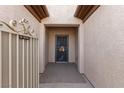 Close-up of the secure, gated front entryway with desert-themed door design at 7927 Crested Starling Ct, North Las Vegas, NV 89084