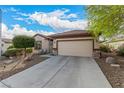 Lovely single-story home featuring desert landscaping, a two-car garage, and a well-maintained driveway at 7927 Crested Starling Ct, North Las Vegas, NV 89084