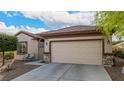 Inviting single-story home featuring desert landscaping and a two-car garage with stone accents at 7927 Crested Starling Ct, North Las Vegas, NV 89084