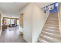Hallway view of plush carpeted staircase and bright living room with wood-look floors at 799 Calm Crystal Ct # Lot 142, North Las Vegas, NV 89081