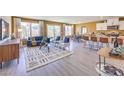 Open-concept living room with wood-look floors and lots of light from large picture windows at 799 Calm Crystal Ct # Lot 142, North Las Vegas, NV 89081