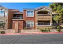 Multi-colored condo building with wrought iron fencing and lush green landscaping at 8101 W Flamingo Rd # 2006, Las Vegas, NV 89147