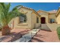 Charming front entrance with stone walkway, illuminated steps, and a well-manicured desert landscape at 8129 Jim Steele Falls St, North Las Vegas, NV 89085