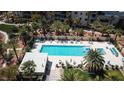 Relaxing pool area surrounded by palm trees, lounge chairs, and umbrellas, perfect for outdoor enjoyment at 8255 S Las Vegas Blvd # 1514, Las Vegas, NV 89123