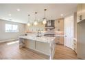 Open concept kitchen with marble island, stainless steel appliances, and pendant lighting at 8316 Broad Peak Dr, Las Vegas, NV 89131
