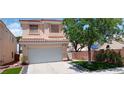 Two story single Gathering home featuring stucco exterior, concrete driveway and front yard featuring mature shade tree at , Henderson, NV 89052