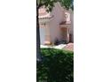 Charming front yard with artificial turf, desert landscaping, and a pathway leading to the front door at , Henderson, NV 89052