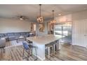 Spacious kitchen island, stainless steel refrigerator and open concept to the living area at 10047 Alden Creek St, Las Vegas, NV 89141