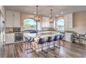A chef's dream kitchen with a massive island, stainless steel oven and seating for seven at 10047 Alden Creek St, Las Vegas, NV 89141