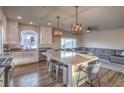 Open-concept kitchen and living area featuring a large island and stainless steel appliances at 10047 Alden Creek St, Las Vegas, NV 89141