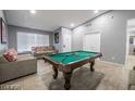 Bright game room featuring a pool table, neutral paint, ceiling fan, tile flooring, and comfortable seating at 1012 Greystone Dr, Las Vegas, NV 89108