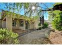 Charming covered back porch with wrought iron fence and a serene view of the desert landscaping at 10302 Cara Mia Ct, Las Vegas, NV 89135