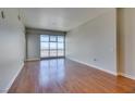 Spacious living room featuring wood floors and large windows with city views at 150 Las Vegas Blvd # 2003, Las Vegas, NV 89101