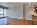 Open concept living room with wood floors and floor to ceiling windows with city views at 150 Las Vegas Blvd # 2003, Las Vegas, NV 89101