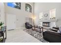 Bright living room with a fireplace, lots of light from large windows, and tile flooring at 1680 Sweet Pea Ave, Las Vegas, NV 89183