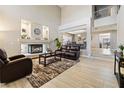 Spacious living room featuring a fireplace, wood-style tile flooring, and stylish furniture at 1680 Sweet Pea Ave, Las Vegas, NV 89183
