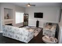 Comfortable living room with ceiling fan, fireplace and cabinet for displaying glassware at 1680 Sweet Pea Ave, Las Vegas, NV 89183