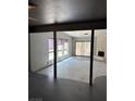 Spacious living room with a stone fireplace, large windows, and sliding door access at 2100 Plaza Del Padre, Las Vegas, NV 89102
