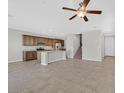 Open-concept kitchen featuring an island, stainless appliances, granite counters, and tile flooring throughout at 2228 Sky Island Dr, Henderson, NV 89002