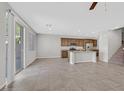 Bright kitchen and living space boasts a large island, stainless steel appliances, and tile flooring throughout at 2228 Sky Island Dr, Henderson, NV 89002