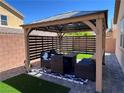 Cozy outdoor patio featuring comfortable seating, an outdoor ceiling fan, and an artificial grass lawn at 248 Windmill Croft Dr, Las Vegas, NV 89148