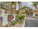 Bella Vista Condominiums community signage with lush landscaping and mature palm trees at 251 S Green Valley Pkwy # 1311, Henderson, NV 89012