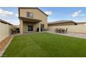 An inviting backyard with an artificial lawn and a patio perfect for entertaining at 2729 Pavehawk Way, Las Vegas, NV 89156